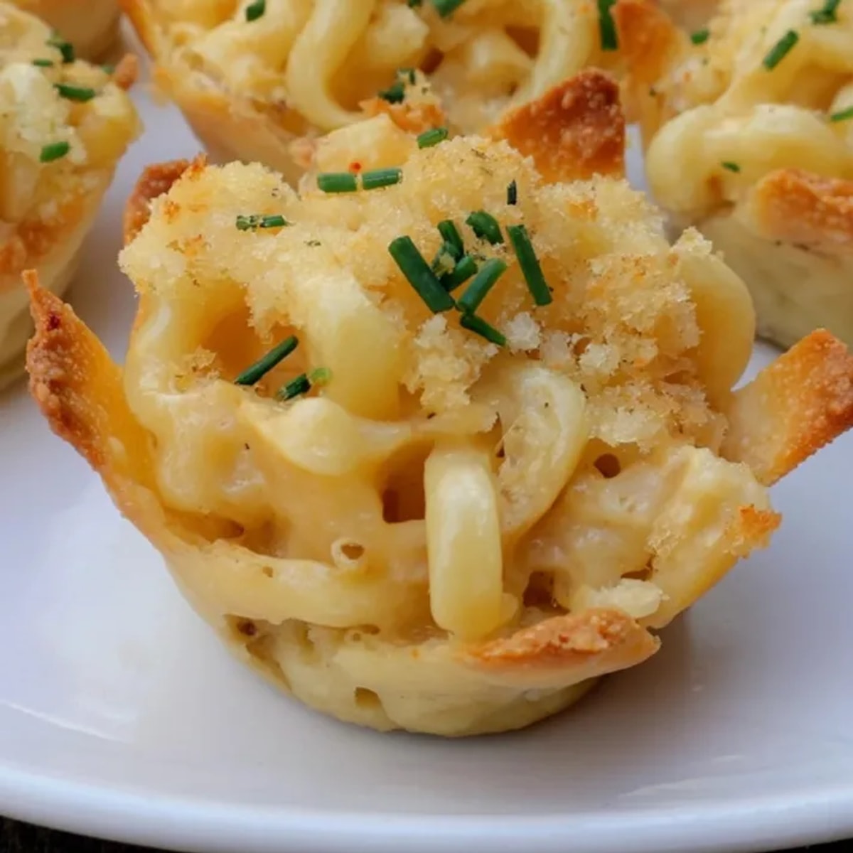 Golden-brown Mac and Cheese Crispy Wonton Cups, cheesy and bubbly, ready to serve.