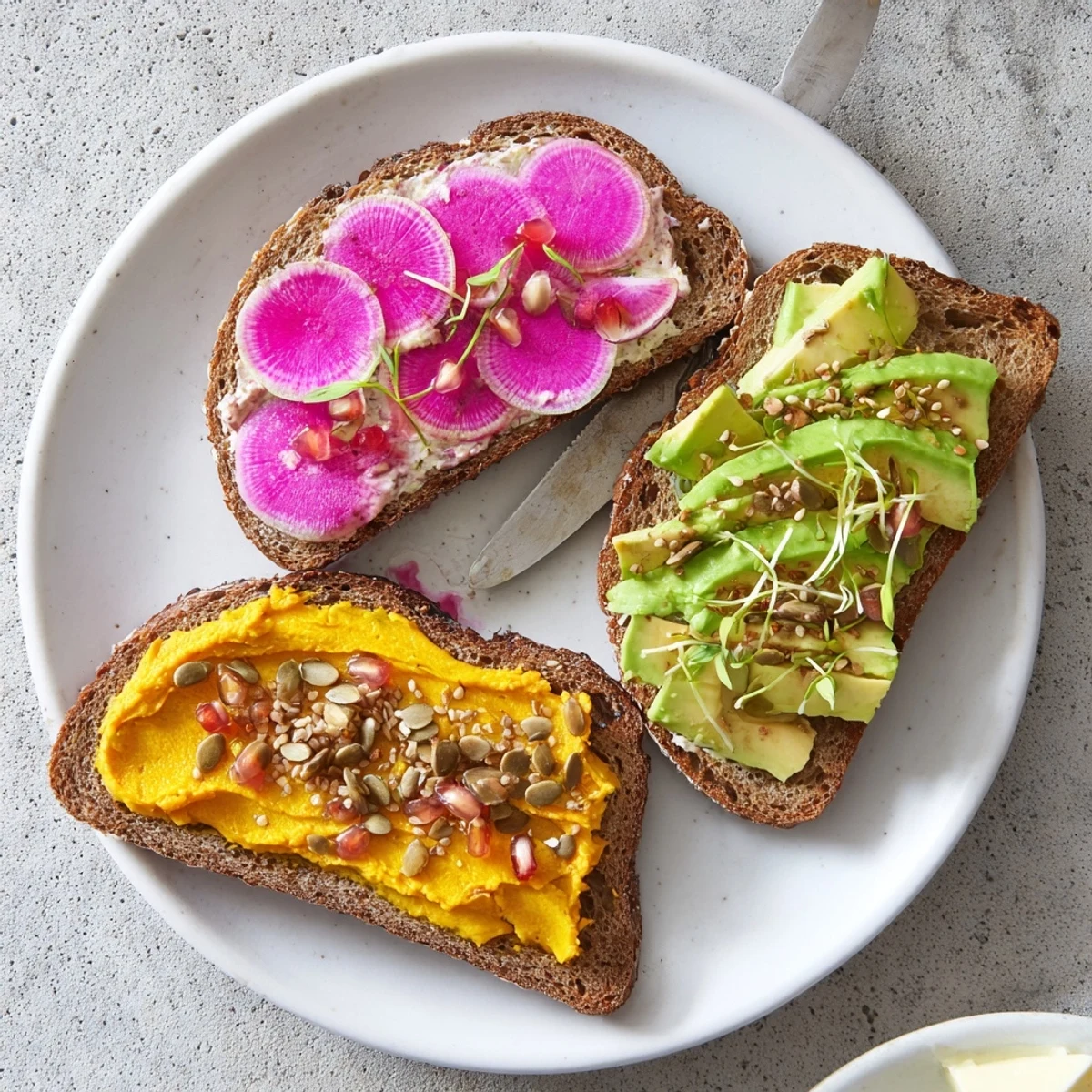 Flavor-packed Bright & Bold Breakfast Toasts adorned with radishes and pomegranate seeds.