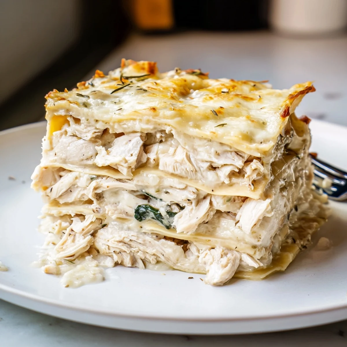 Delicious rosemary chicken lasagna, baked until golden and cheesy with fragrant herbs.  