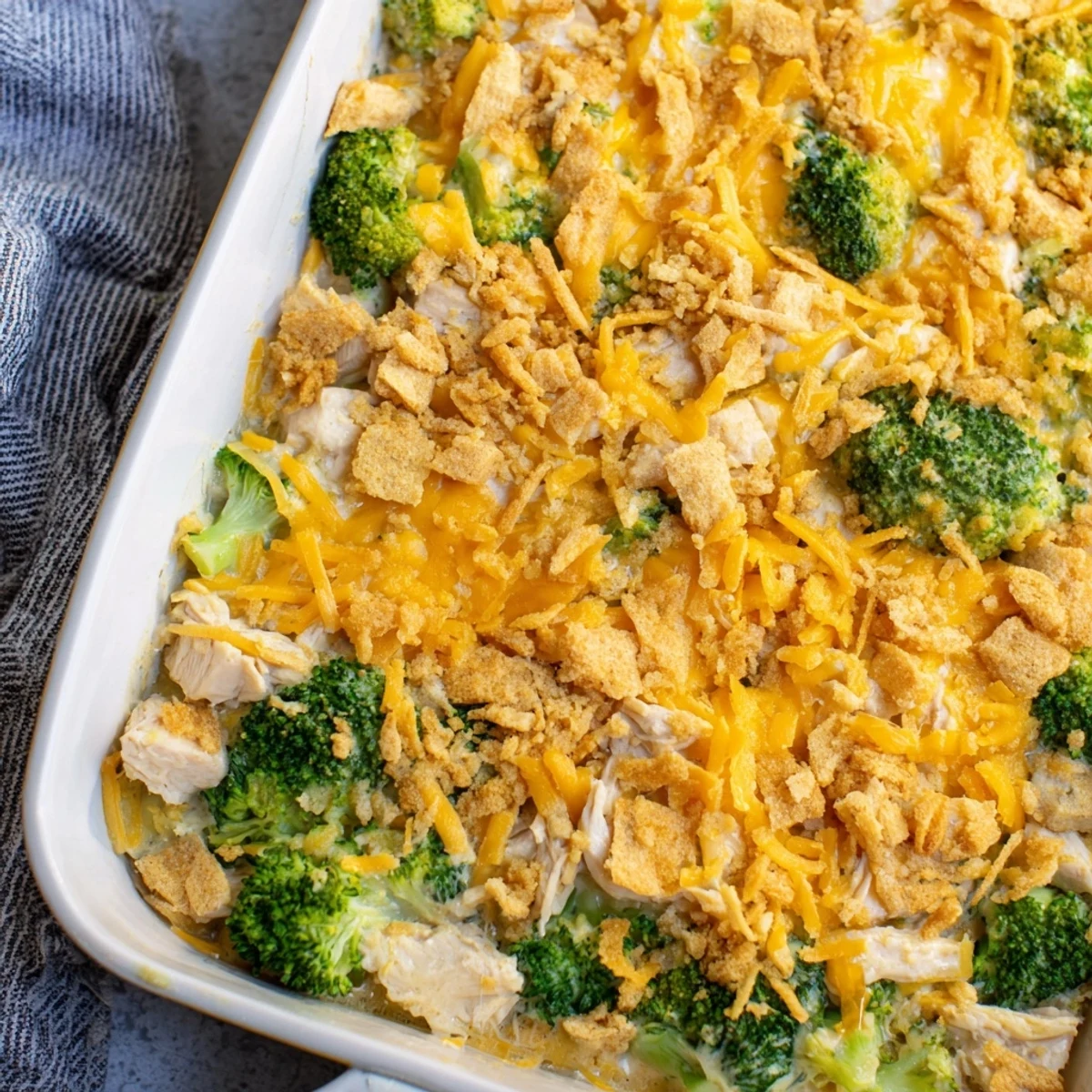 A close-up of a creamy Chicken & Broccoli Cheddar Bake—cheesy, and ready for serving.