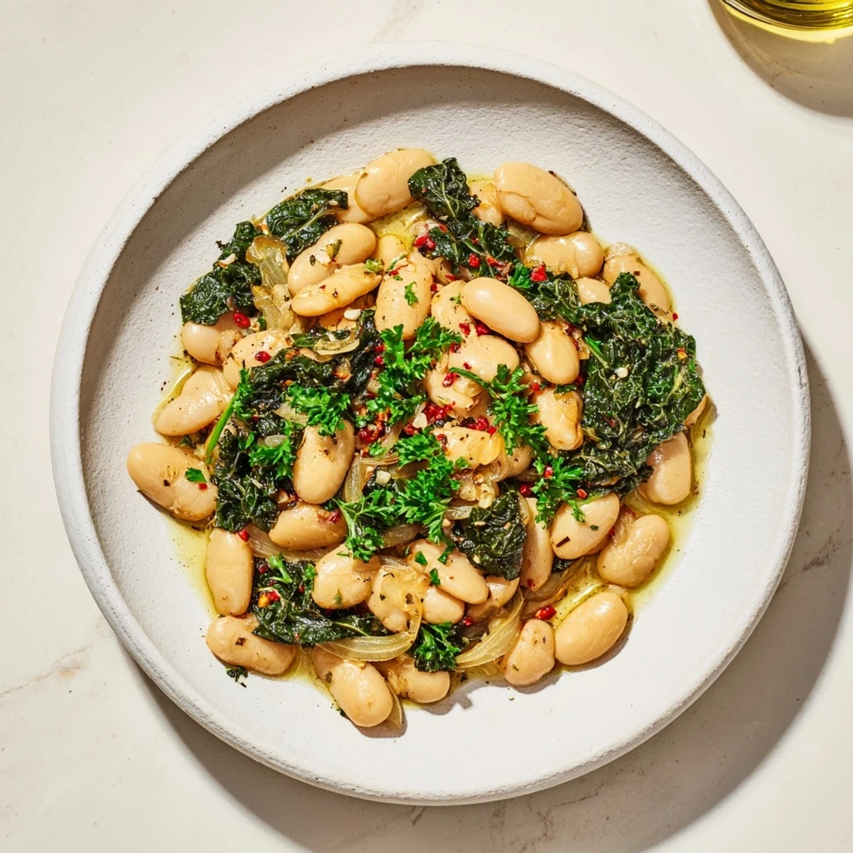Fragrant Garlicky Beans with Winter Greens, featuring tender greens and creamy beans, ready to serve warm.