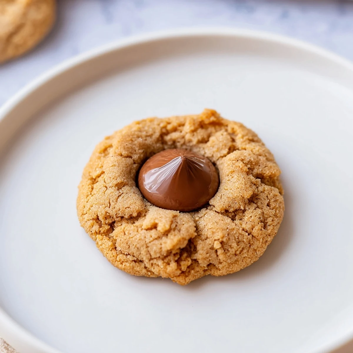 Golden brown 3-Ingredient Peanut Butter Blossoms, cooling on a rack, ready to enjoy this classic treat.