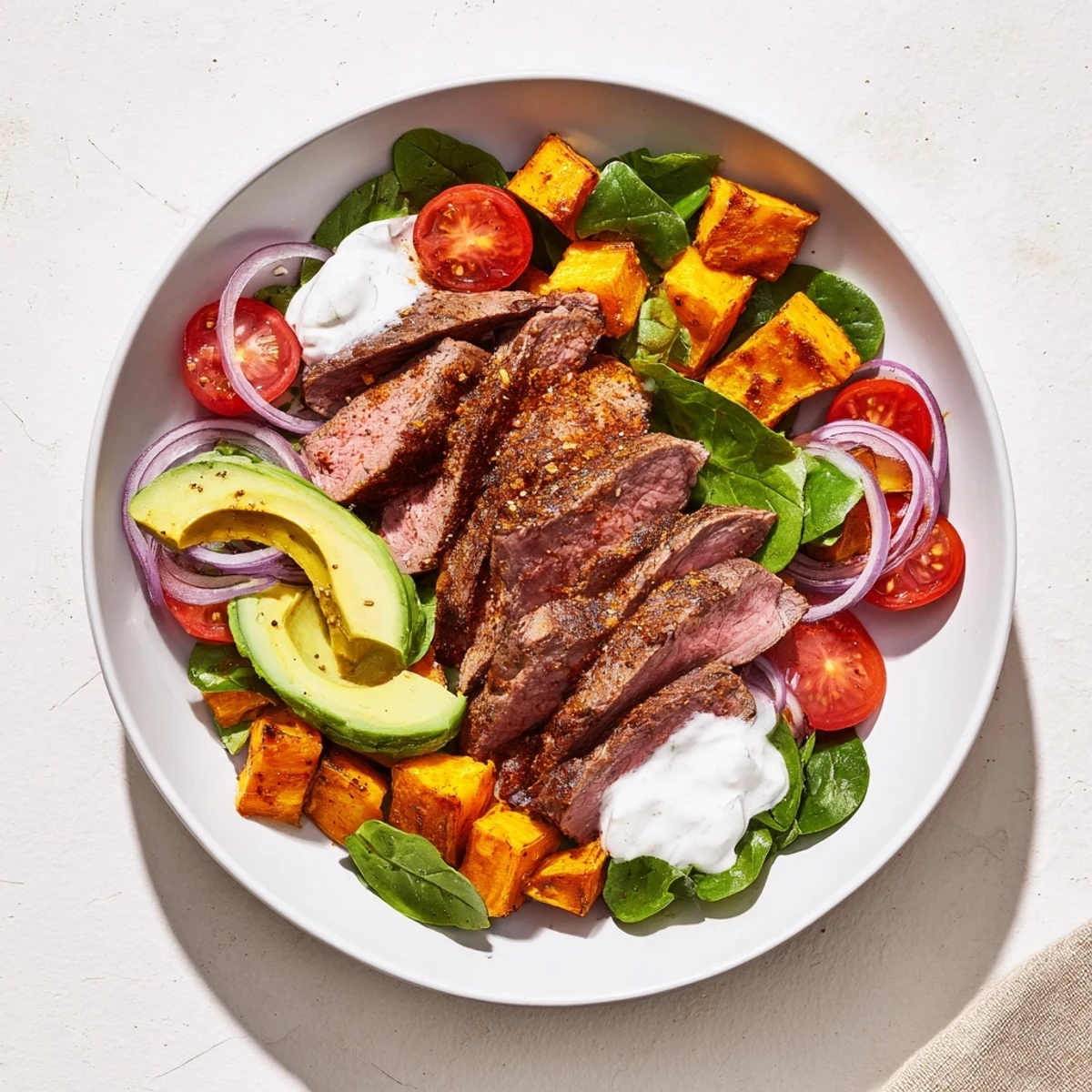 Golden roasted sweet potatoes and juicy beef star in this colorful Beef Avocado Sweet Potato Bowl.