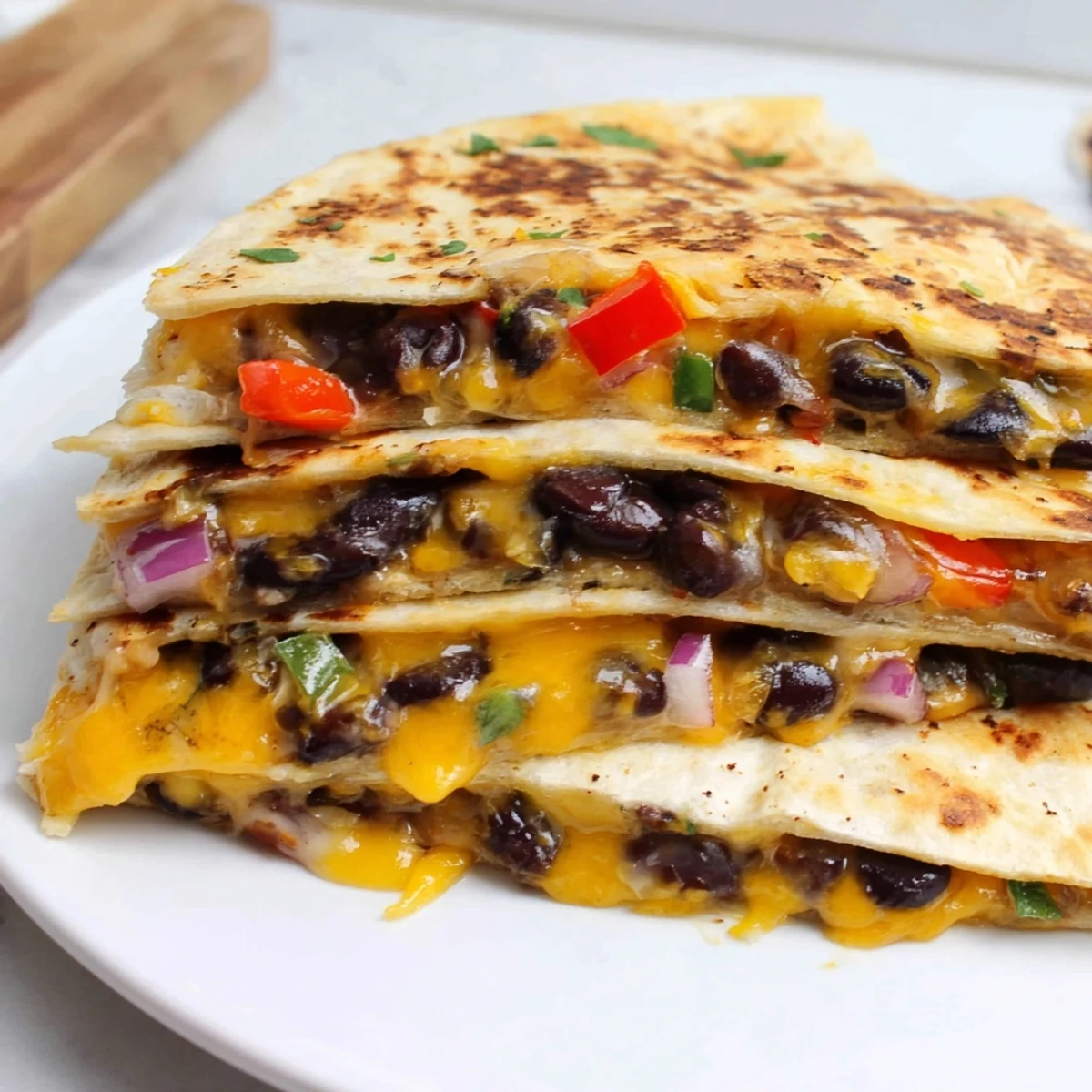 Golden-brown Black Bean Quesadilla, cheesy and flavorful, ready to be cut into wedges.