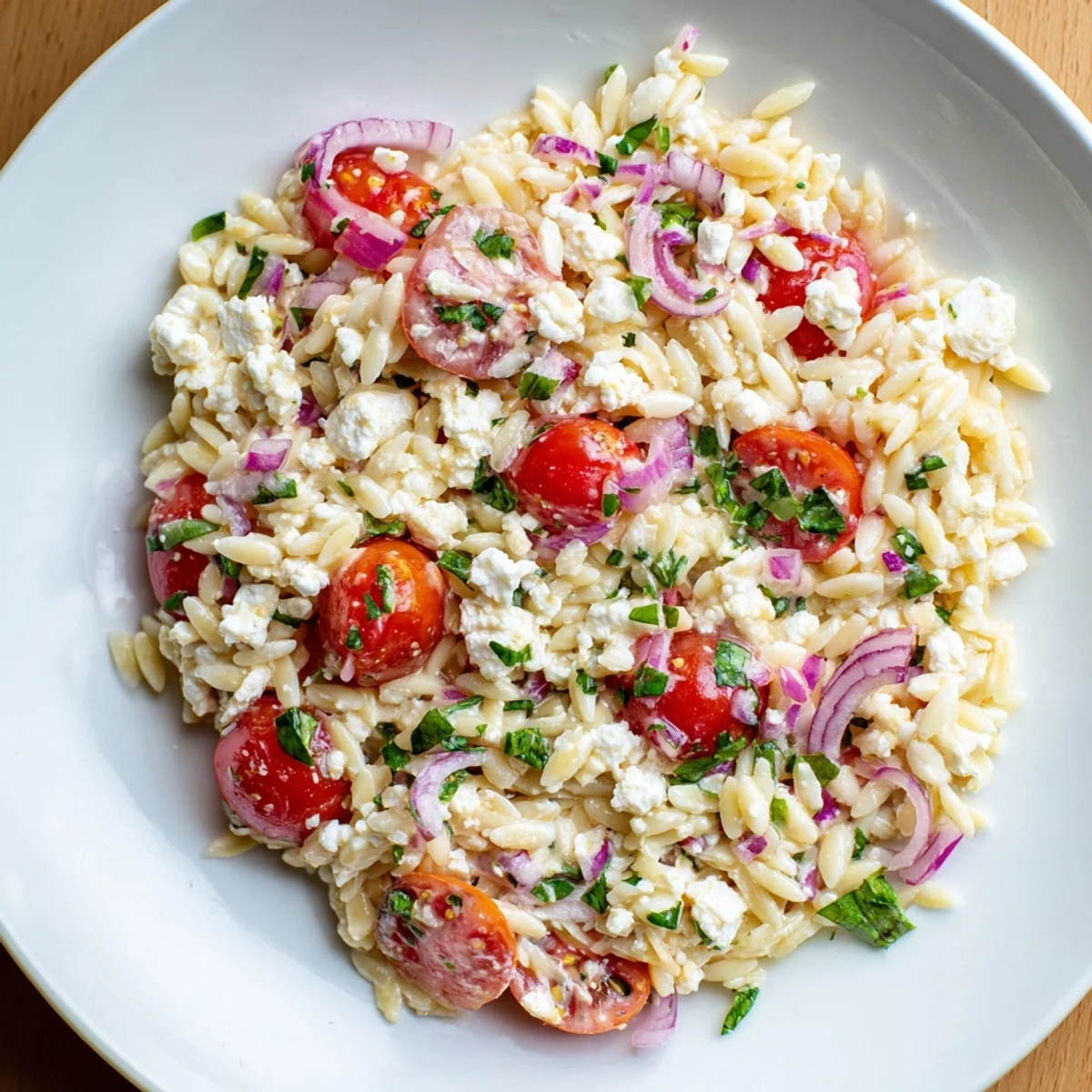 Creamy crumbled feta cheese and juicy tomatoes complement this refreshing Tomato Feta Orzo dish.
