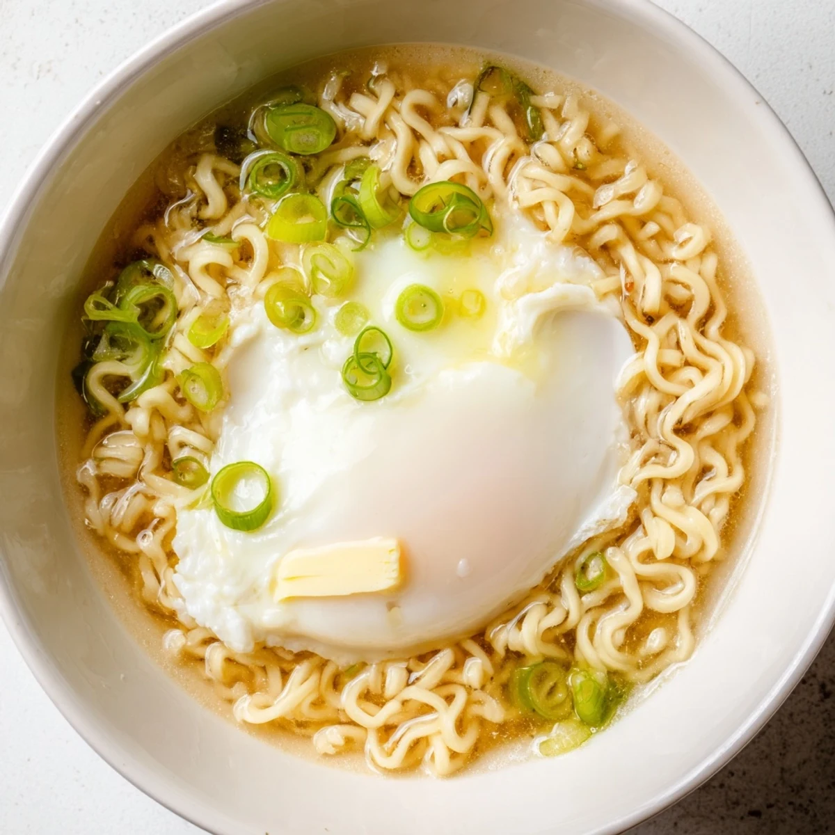 Creamy Upgrade Instant Ramen with soft runny egg and vibrant scallions, ready to enjoy.