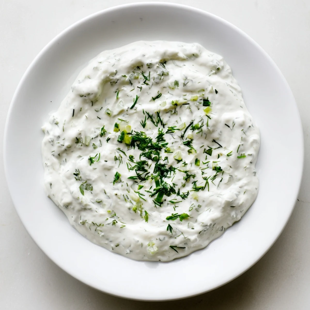 A vibrant bowl of flavorful Greek Yogurt Ranch Dip, perfect for dipping crunchy vegetables.