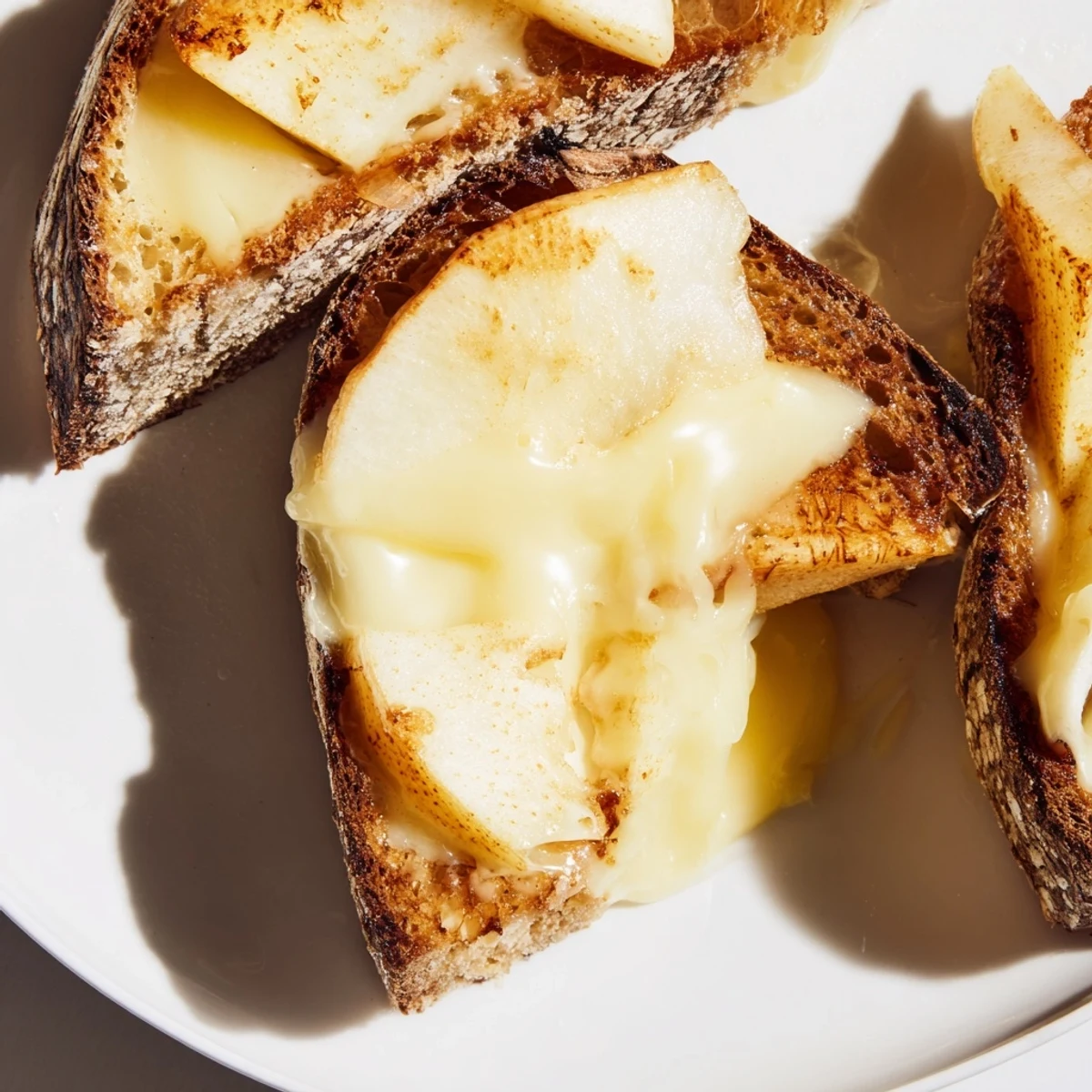 Smoked Gouda & Apple Grilled Cheese sandwich, perfectly grilled and sliced, revealing layers of gooey cheese and tart apple.