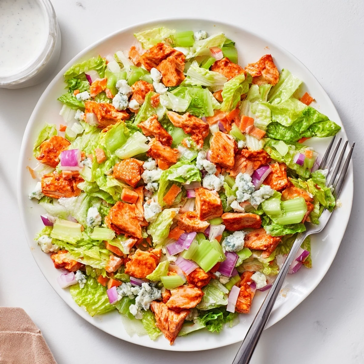 Chopped romaine lettuce tossed with spicy buffalo chicken, celery, and creamy blue cheese crumbles.
