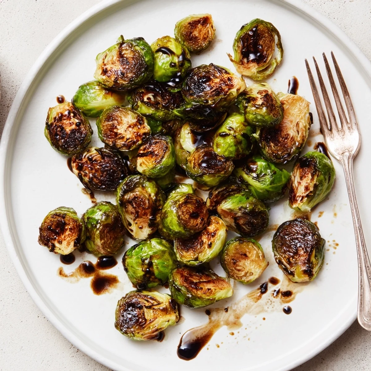 Roasted Brussels sprouts with balsamic reduction served as a golden, savory-sweet side dish.