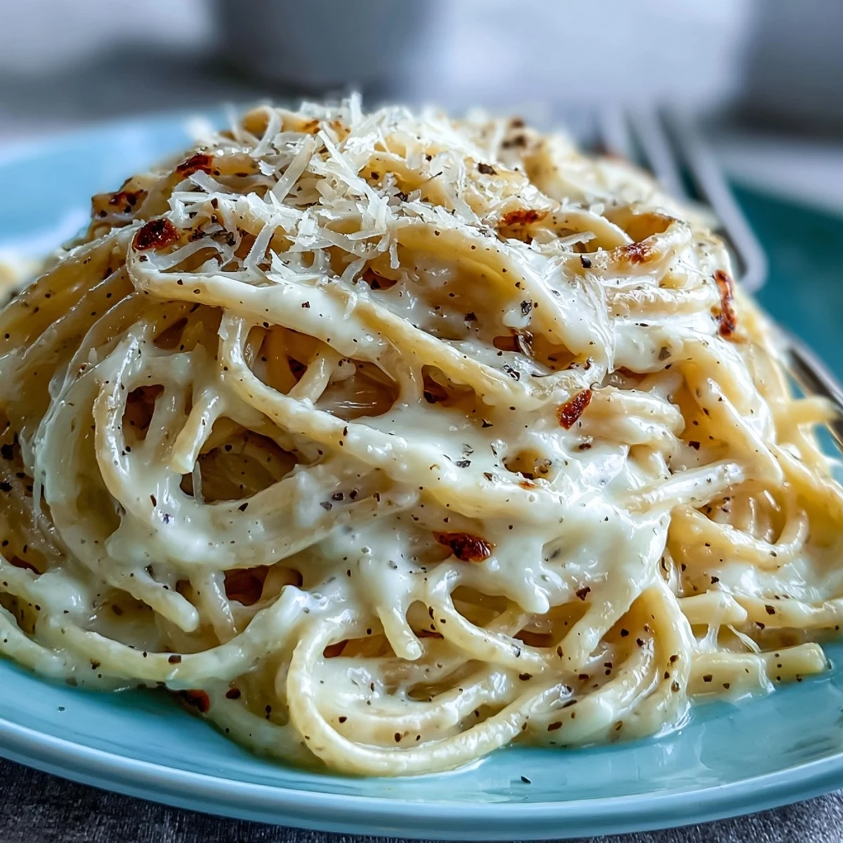 Steaming Cacio e Pepe pasta twirled on a fork, coated in creamy Pecorino Romano sauce.