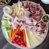 A beautifully arranged Budget-Friendly Family Spread with hummus and olives ready to delight guests.