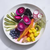 The Neon Night features a striking arrangement: pickles, eggs, and fruit bursting with color.