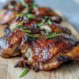 Sliced Five-Spice Roast Ducks served alongside fluffy jasmine rice and stir-fried greens on an elegant dinner plate.