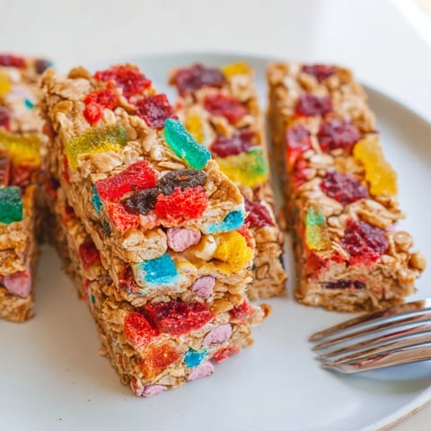 Colorful homemade gummies atop DIY snack bars with oats and freeze-dried candy.  