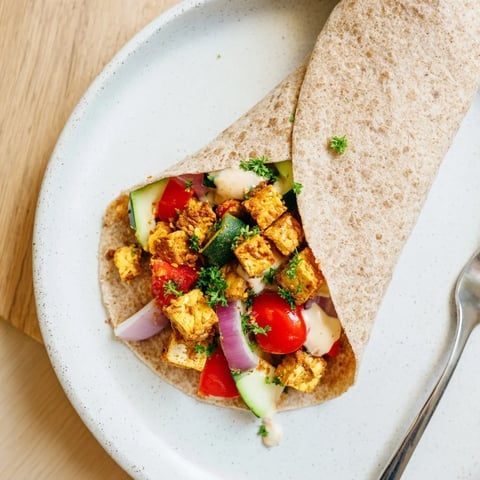 Vegan Viral Recipe Re-make featuring roasted tofu and vibrant vegetables in wraps.  