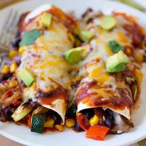 Vibrant Farmers Market Vegetarian Enchiladas topped with melted cheese and fresh cilantro.  