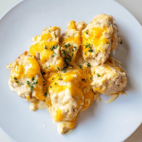 Juicy Cheddar Ranch Chicken Bake topped with melted cheese and fresh herbs.  