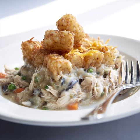 Golden-brown tater tots topping a creamy, savory Tater Tot Chicken Pot Pie, ready to enjoy.