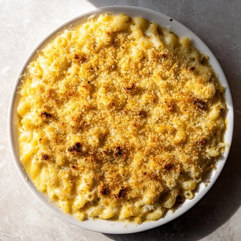 Golden, bubbling Old-Fashioned Baked Mac & Cheese offers a cheesy, comforting family meal.