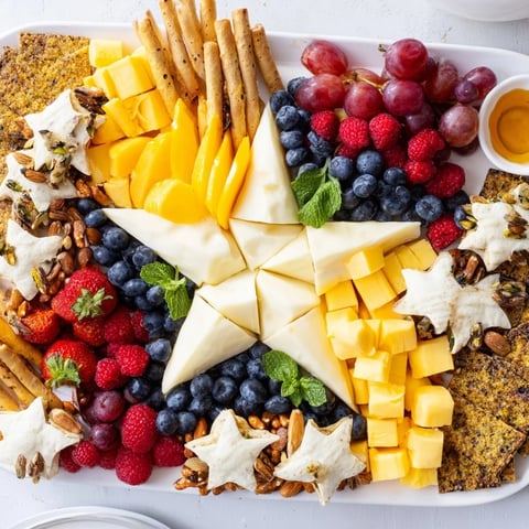 Festive Shooting Star Snack Board features colorful fruits, cheeses, crackers, and sweet treats ready to enjoy.