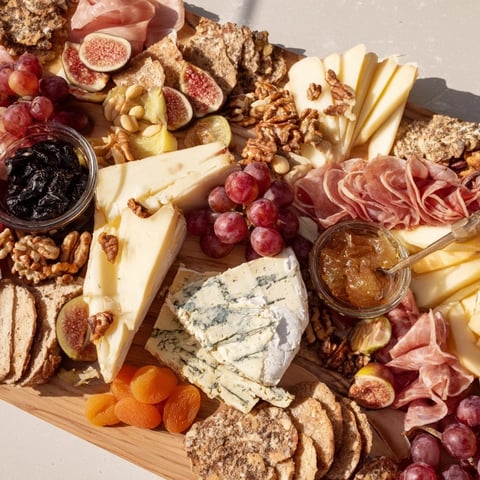 A beautifully arranged 2026 Wine Pairing Board overflowing with cheeses, fruits, and meats, ready to enjoy.