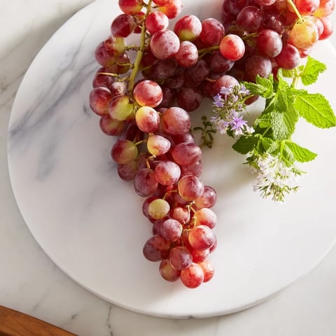 Fresh, colorful grapes spilling over a board, ideal for a quick, healthy snack platter.