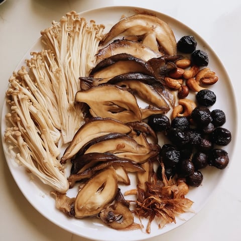 A close shot displays the arranged Umami Bomb Asian Delight, showcasing rich, savory flavors on a board.
