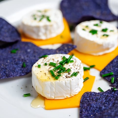 Appetizing "Stepping Stones" appetizer; cheese rounds on blue corn chips offer visual and tasty appeal.