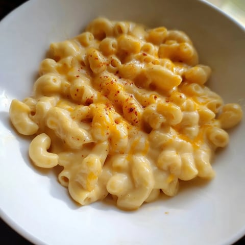 Golden, bubbly Tinis Recession Mac and Cheese in a baking dish, ready for a comforting meal.
