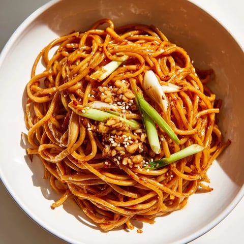 Steaming bowl of Garlic Chili Oil Noodles, a spicy and flavorful vegan main dish.