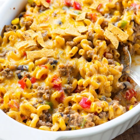 Close-up of a cheesy Mac and Cheese Taco Casserole, ready to be served with toppings.