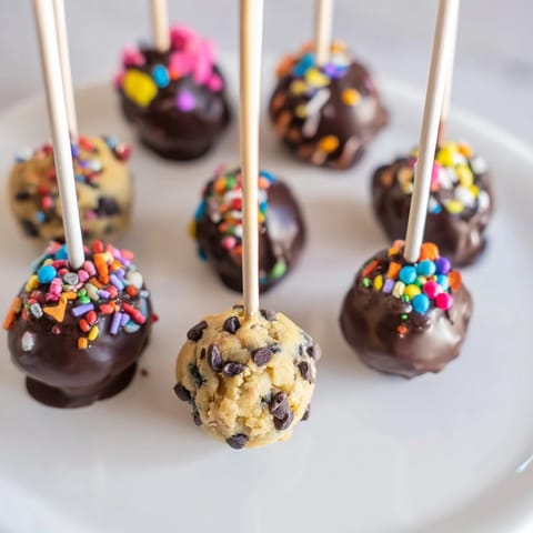 Playful, bite-sized Charcuterie Board Cookie Dough Pops ready for your dessert table.  