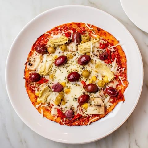 Cheesy tortilla pizza featuring melted mozzarella and parmesan cheese with delicious pantry ingredients atop crispy base.