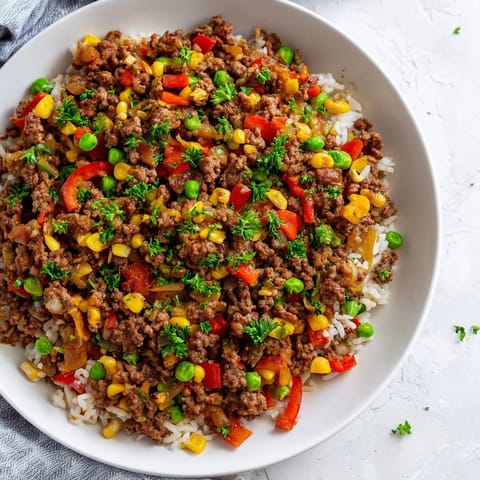 A close-up of a steaming ground beef skillet, perfect for a quick, comforting weeknight dinner.