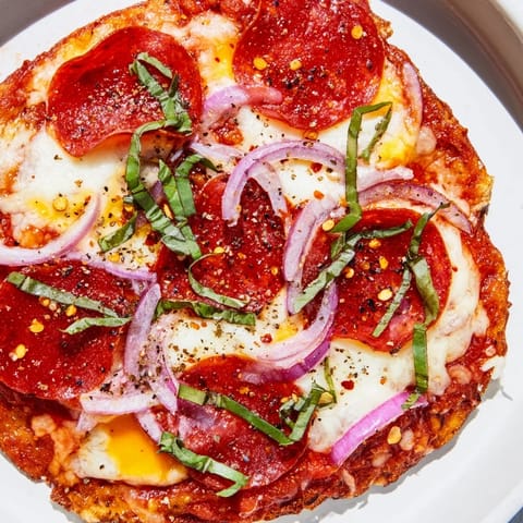 Crispy, golden-crusted Hot Honey Pepperoni Flatbread, ready to slice with melty cheese and fresh basil.