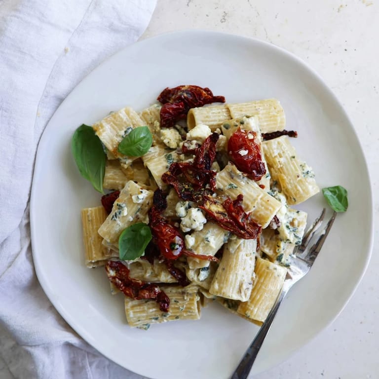 Vibrant Baked Feta Pasta 2.0 featuring golden tomatoes and herby basil, ready to enjoy.  