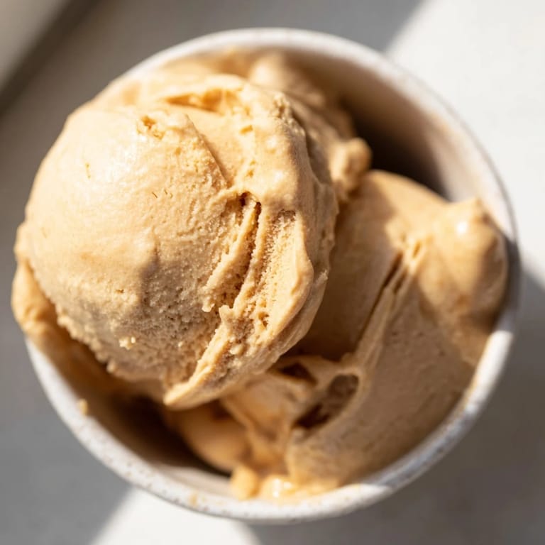 A healthy serving of Peanut Butter Banana Ice Cream, blended to a smooth, soft-serve perfection, dairy-free.
