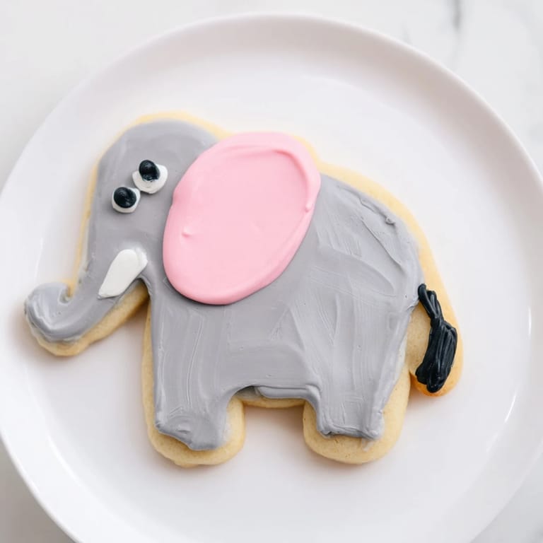 Warm and sweet, decorated Biscuits Amical Éléphant Géant cookies on a baking sheet, ready to cool.