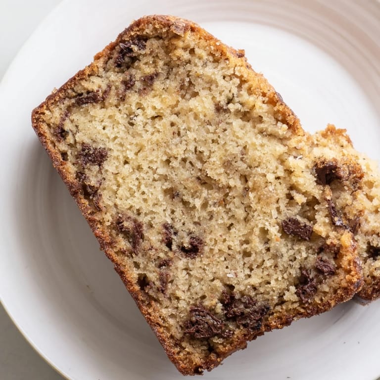 Close-up of moist, homemade Banana Bread, with optional walnuts, delicious and inviting.