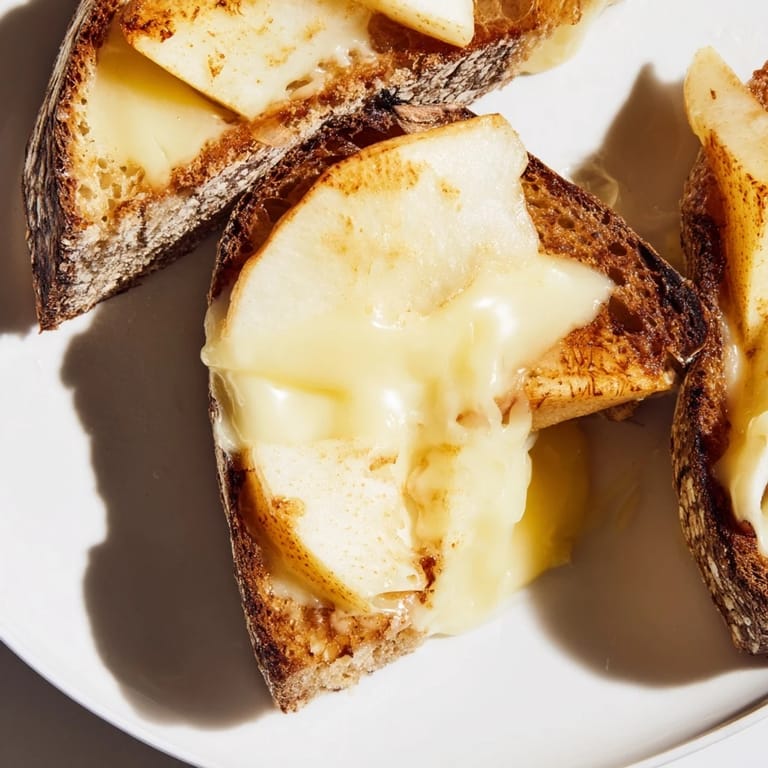Smoked Gouda & Apple Grilled Cheese sandwich, perfectly grilled and sliced, revealing layers of gooey cheese and tart apple.