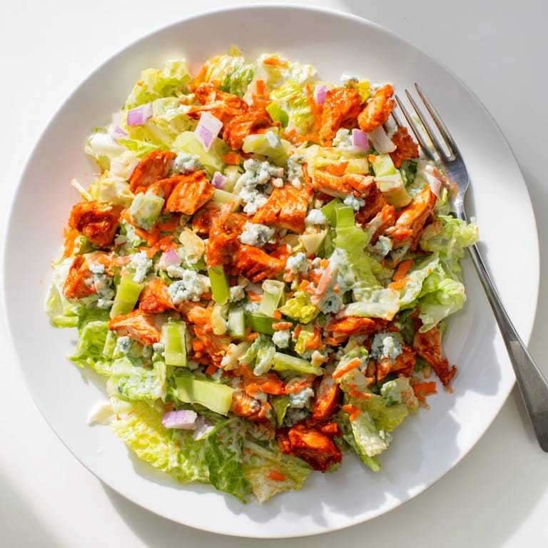 Freshly prepared Buffalo Chicken Chopped Salad with crisp vegetables, ideal for a quick, zesty lunch.